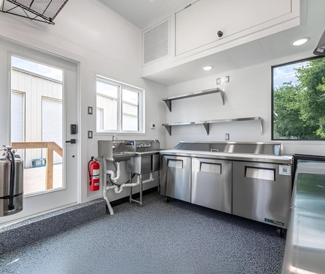 Commercial kitchen with Trusscore wall panels and stainless equipment.