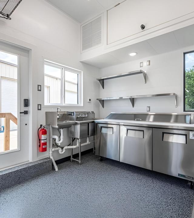 Commercial kitchen with Trusscore wall panels and stainless equipment.