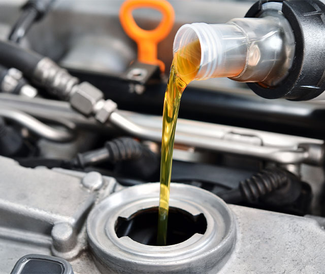 Snowblower oil leaking into a tank.