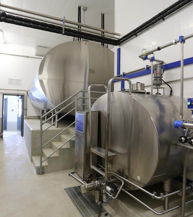 Trusscore wall panels in a dairy processing room with tanks.