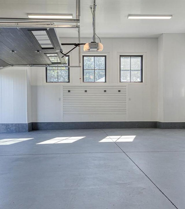 Bright garage with Trusscore wall panels and SlatWall storage system.