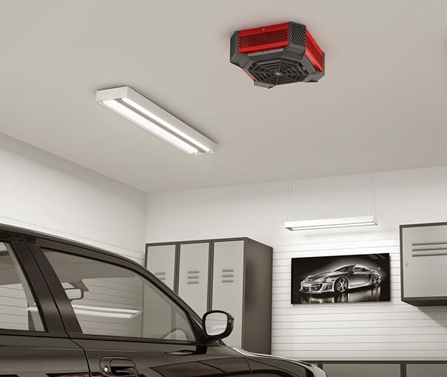 Ceiling fan heater installed in a garage, above a black car.