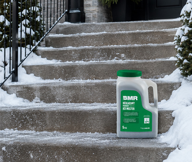 5 kg BMR ice melter container placed in front of snow-covered steps to help prevent icy surfaces.