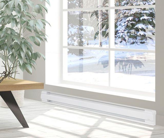 Electric baseboard heater under the window of a bright room.