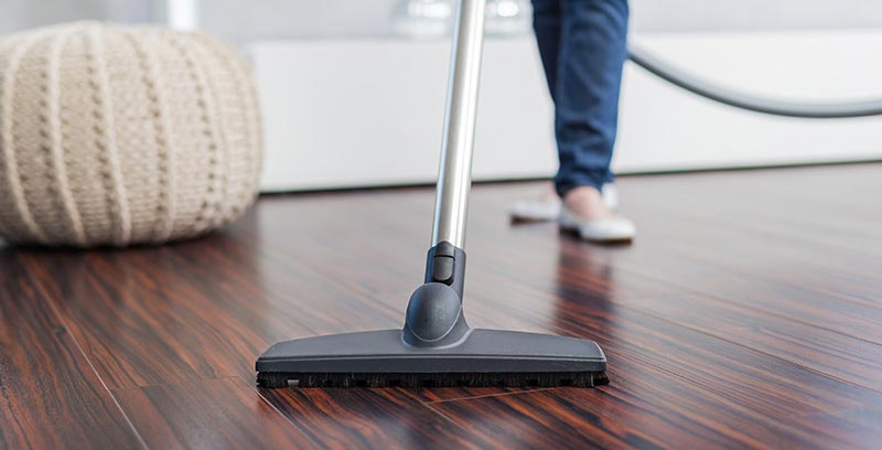 Women vacuuming the floor