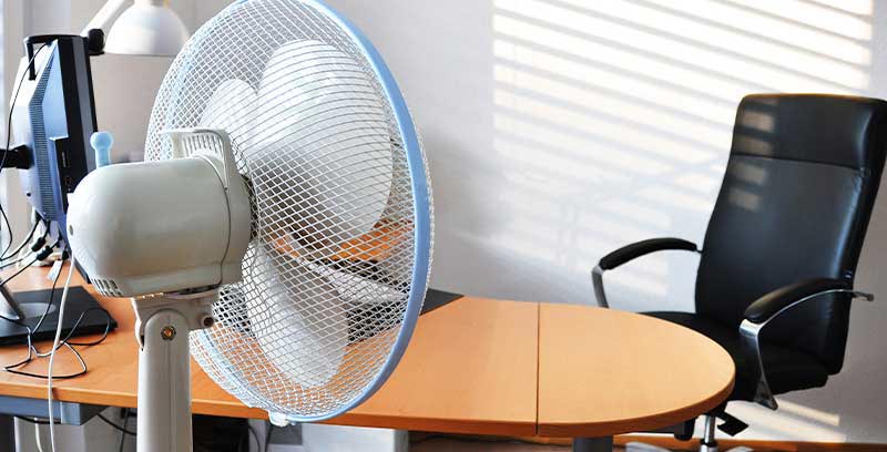 Pedestal oscillating fan in a office