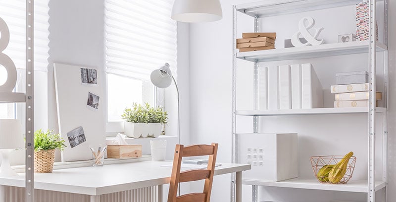 White room with bookcase and table