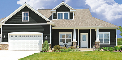 Modern single-family home with black exterior siding, beige roof, white double garage, and well-maintained landscaping.