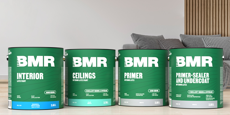 Four gallons of BMR interior paint&mdash;including interior latex paint, ceiling paint, primer, and primer-sealer&mdash;displayed in a modern living room.